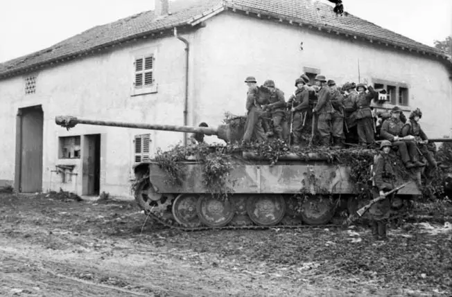 German soldiers riding on a Panther tank during WW2