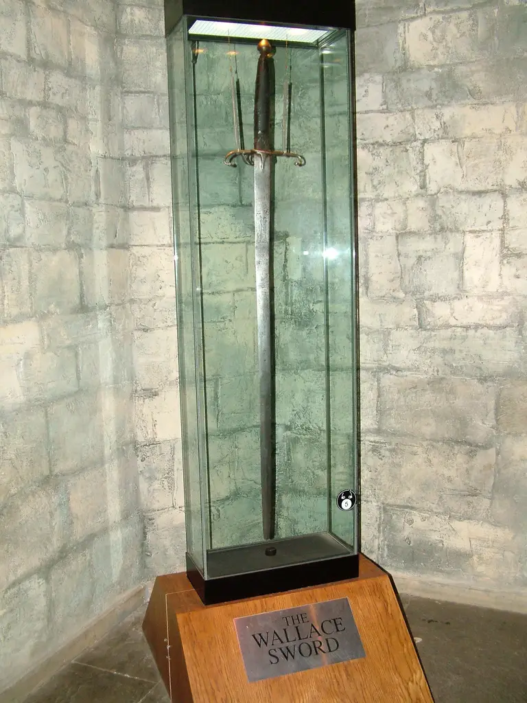 an ancient sword in a glass display case